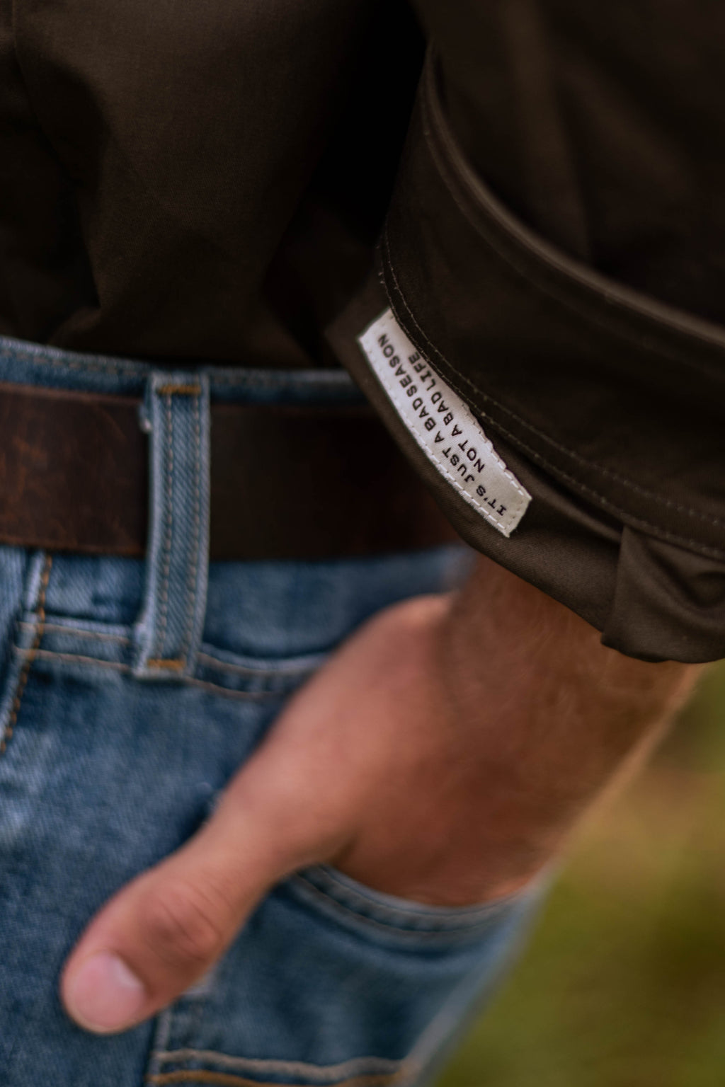 Men's cotton work shirt showing hidden motivational tag inside